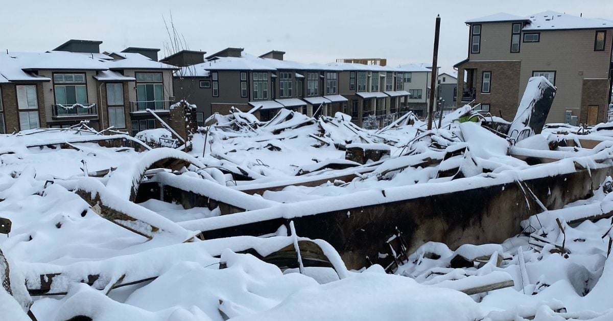 Snow covers building debris from Marshall Fire in Colorado.