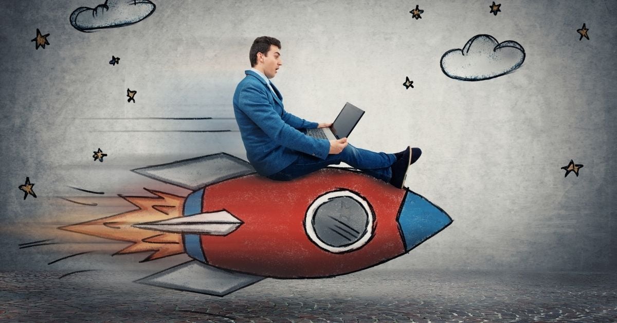 Businessman flying on a rocket looking at his laptop